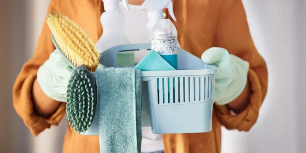 Cleaner, cleaning supplies and ready to start work, prepare for labor and hygiene with brush, bottles and liquid detergents. Domestic, woman and female employee working service, fresh space and cloth.